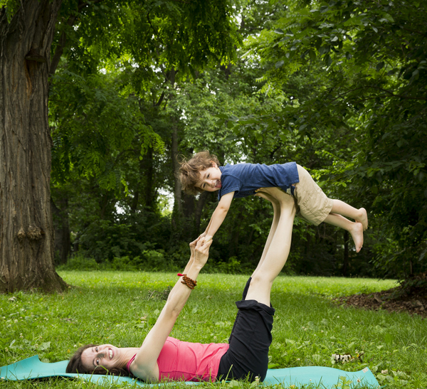 ©Rebecca Emily Drobis ALL RIGHTS RESERVED Teachers and families from Lil Om Studio practice poses outdoors.