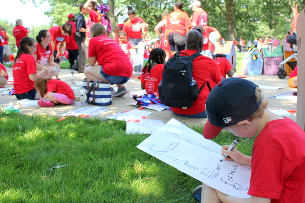 Moms Clean Air Force Play-In for Climate Action 2015 child writing sign