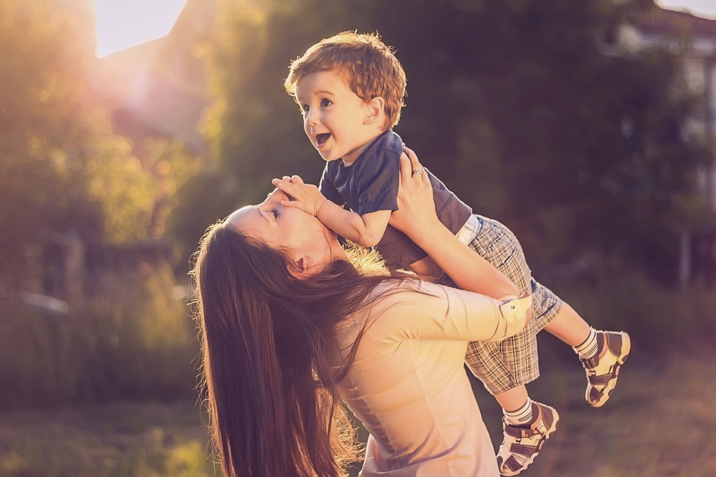 Mother lifting her son up