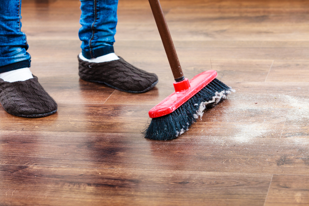 Sweeping wooden floor.